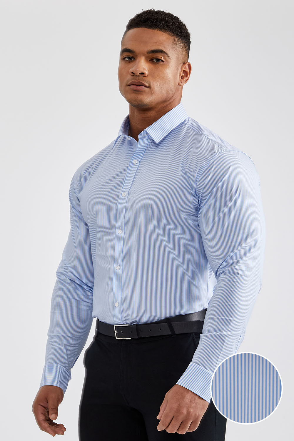 Dressing in a light blue shirt, gray pants, a colorful pattern tie, a young  black businessman is standing outside an office building, lost in thought  Stock Photo - Alamy